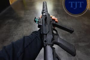 Semiautomatic rifle with red dot optic and adjustable stock at a New Jersey shooting range