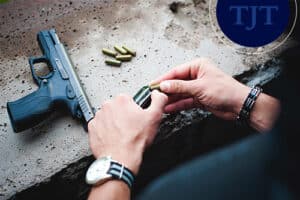 Person loading bullets into a firearm magazine